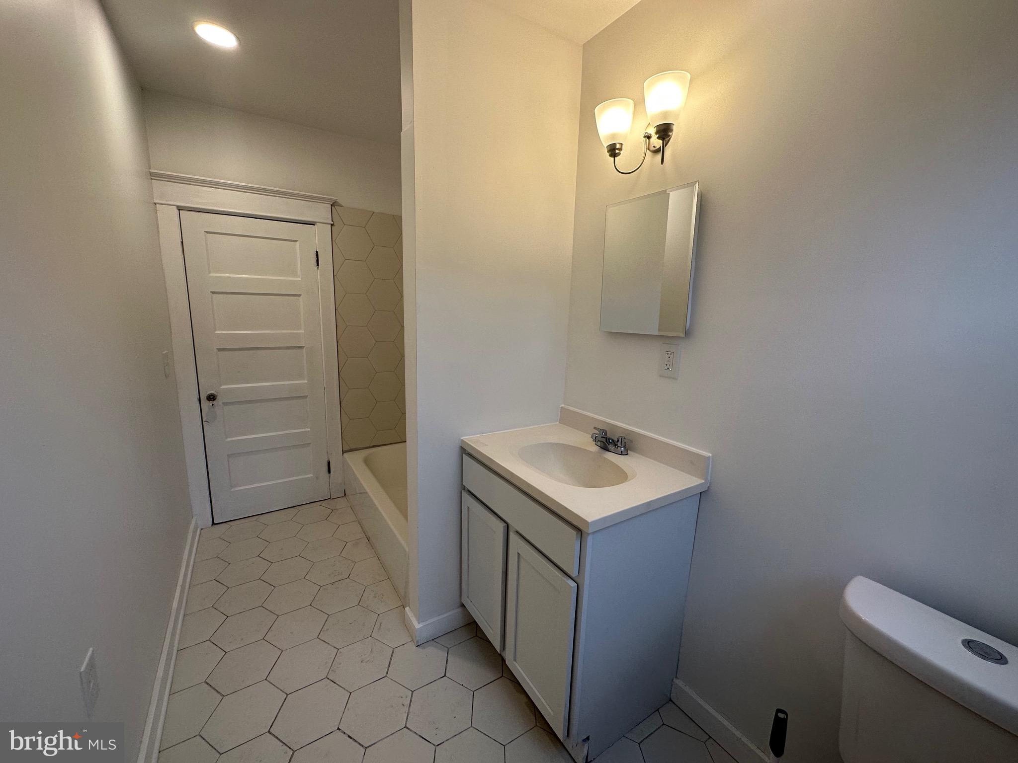 4227 Euclid Avenue, Unit B Baltimore, MD 21229 - Photo 2 of 87 a bathroom with a sink a toilet and mirror