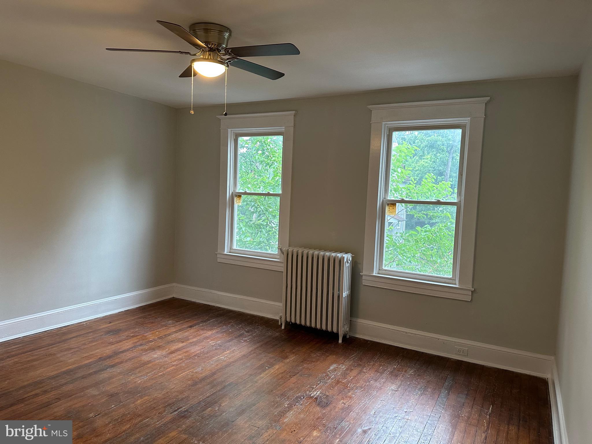 4227 Euclid Avenue, Unit B Baltimore, MD 21229 - Photo 25 of 87 a view of an empty room with wooden floor and a window