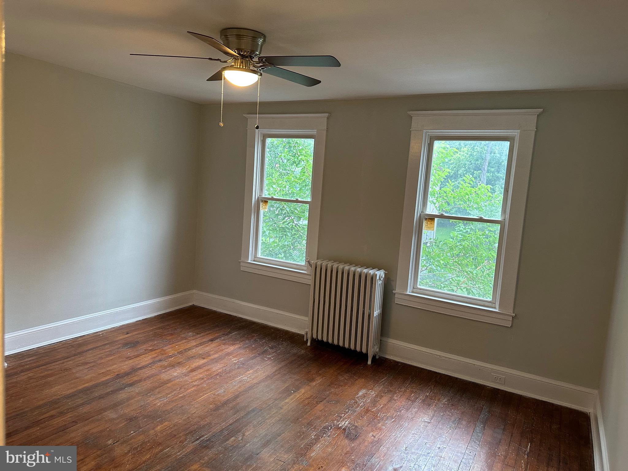 4227 Euclid Avenue, Unit B Baltimore, MD 21229 - Photo 26 of 87 a view of an empty room with wooden floor and a window