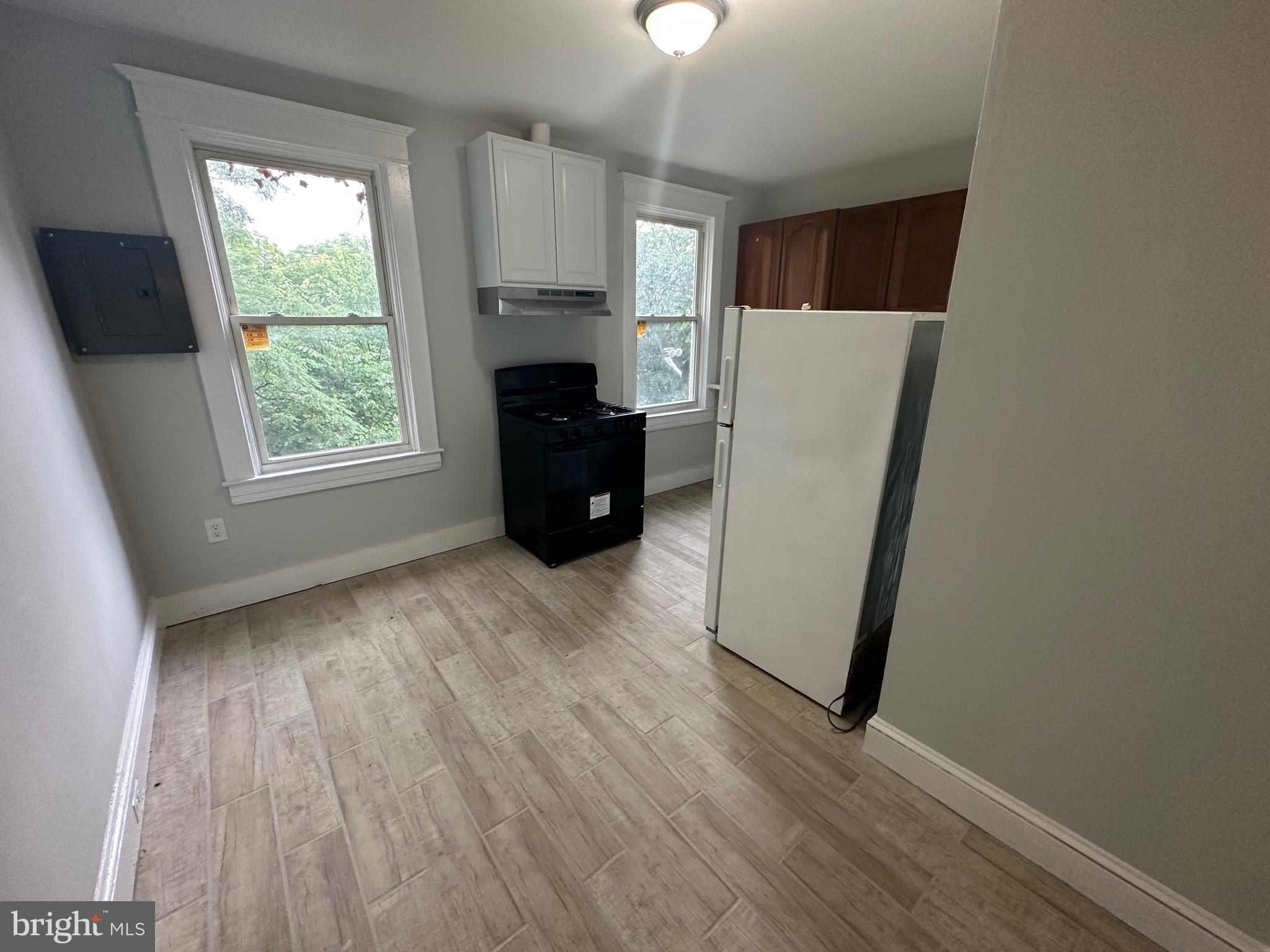 4227 Euclid Avenue, Unit B Baltimore, MD 21229 - Photo 27 of 87 an empty room with wooden floor and a window
