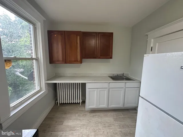 a white refrigerator freezer and a stove sitting inside of a kitchen