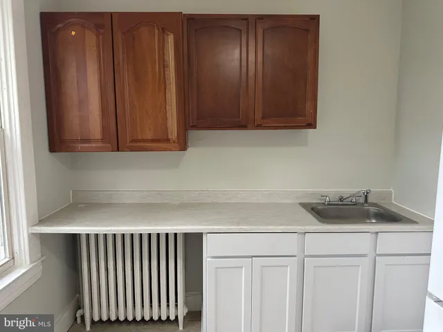 a white refrigerator freezer and a stove sitting inside of a kitchen