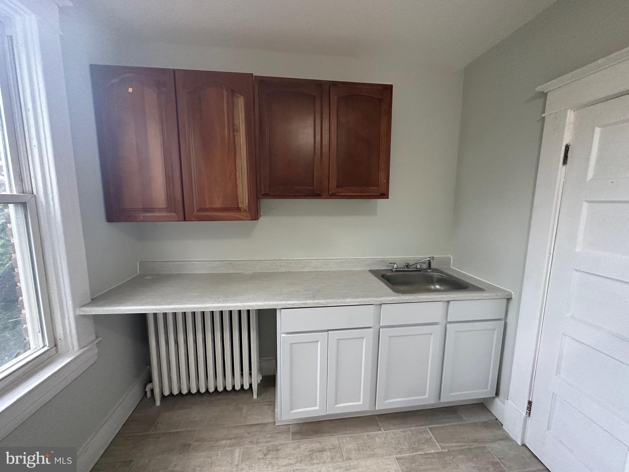 4227 Euclid Avenue, Unit B Baltimore, MD 21229 - Photo 32 of 87 a kitchen with stainless steel appliances granite countertop a sink and cabinets with wooden floor