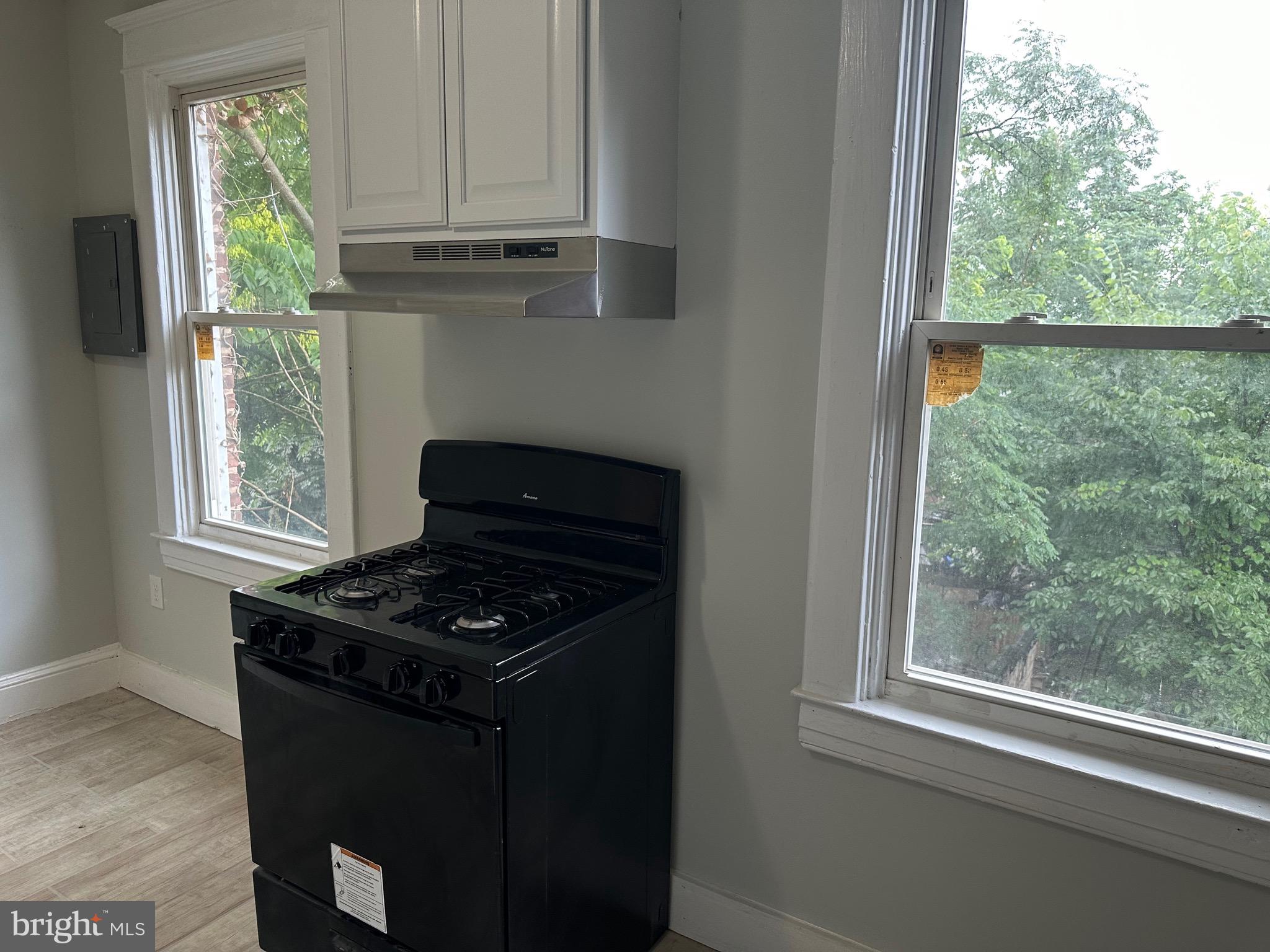 4227 Euclid Avenue, Unit B Baltimore, MD 21229 - Photo 34 of 87 a kitchen with granite countertop a stove a sink and a window