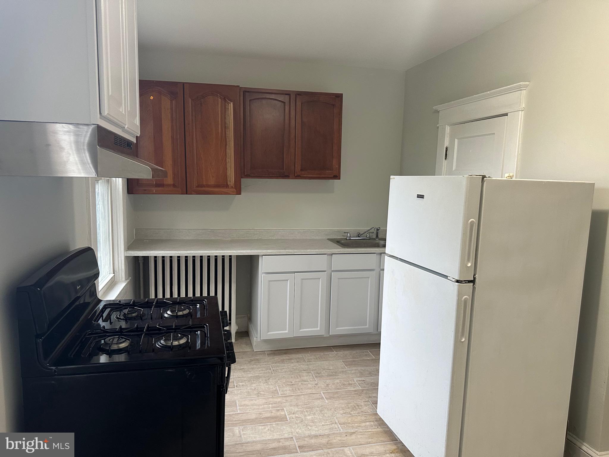 4227 Euclid Avenue, Unit B Baltimore, MD 21229 - Photo 39 of 87 a kitchen with a refrigerator and a stove