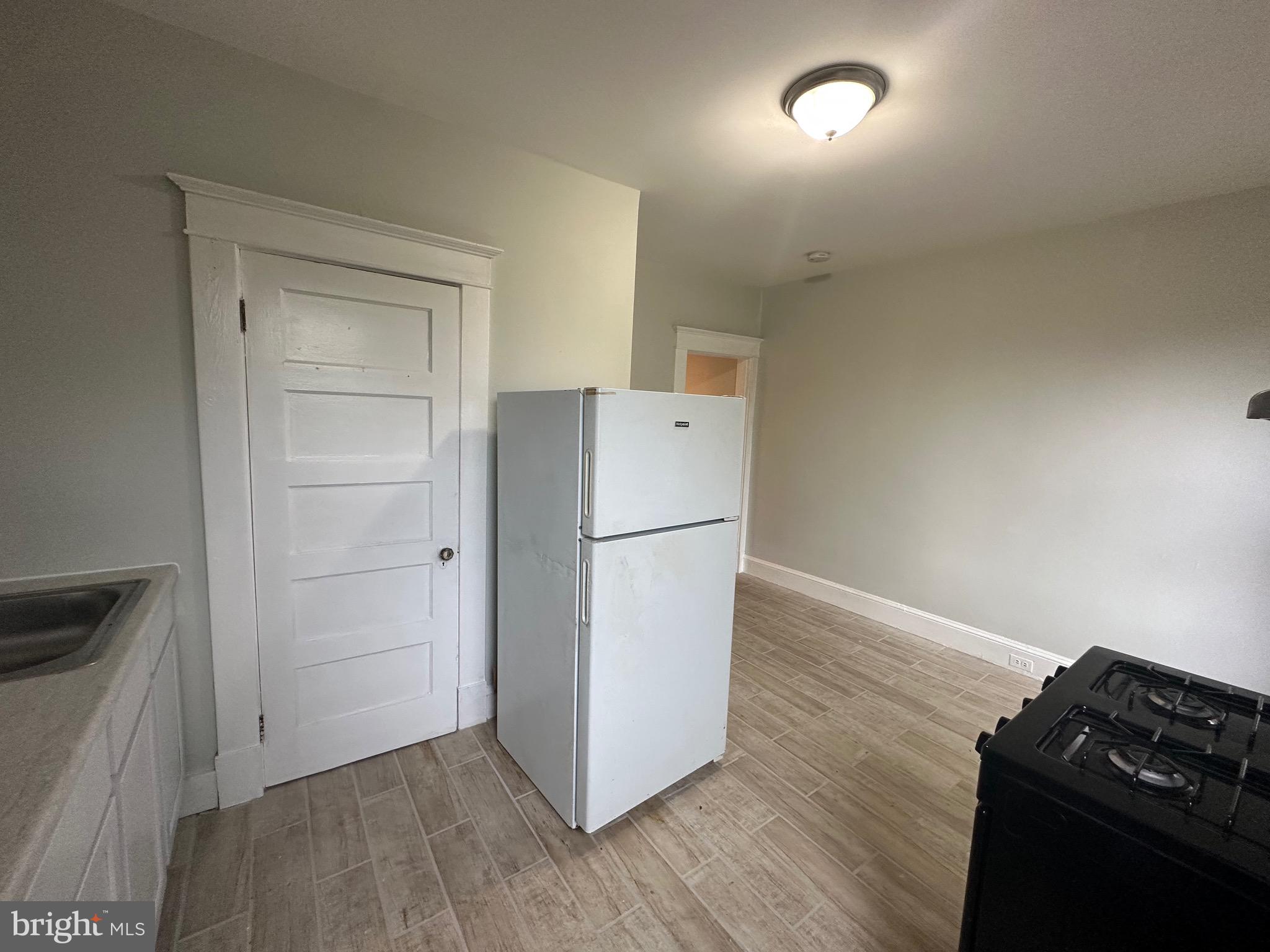 4227 Euclid Avenue, Unit B Baltimore, MD 21229 - Photo 42 of 87 a kitchen with a refrigerator and a stove top oven