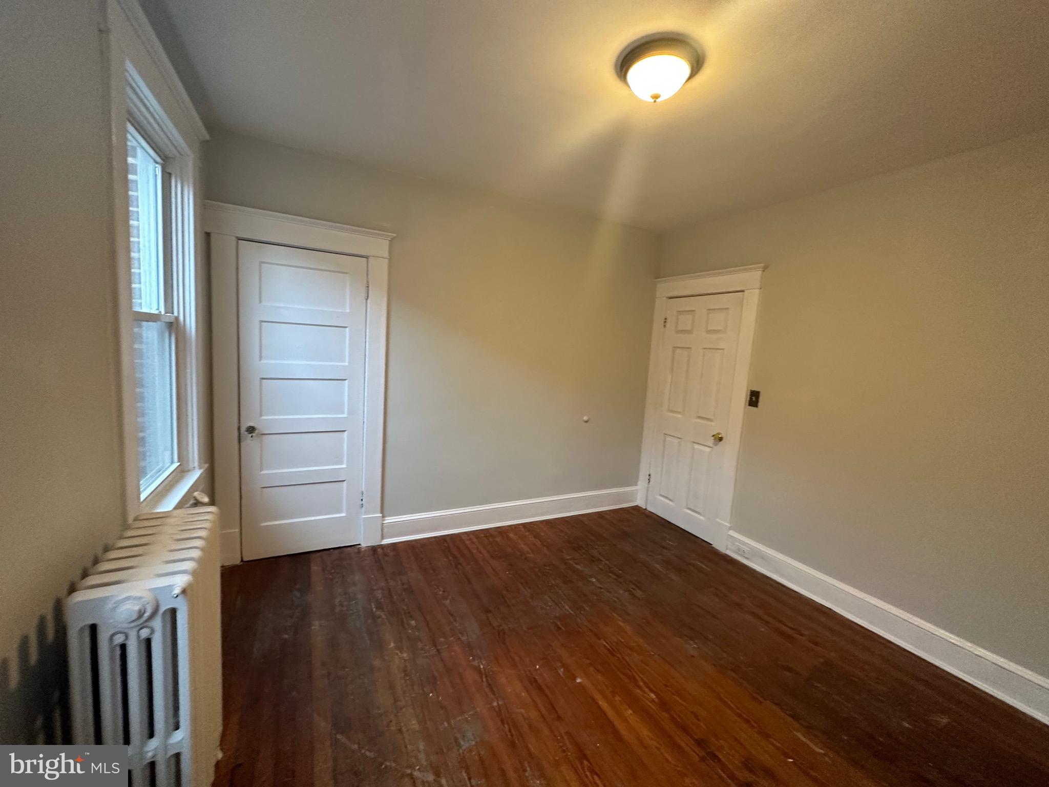 4227 Euclid Avenue, Unit B Baltimore, MD 21229 - Photo 43 of 87 an empty room with wooden floor and windows