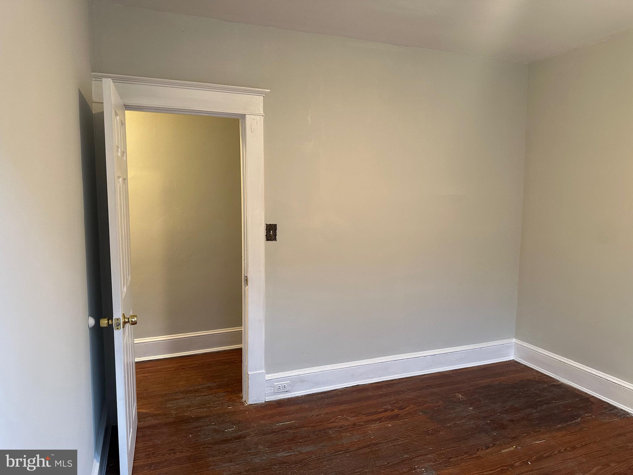 4227 Euclid Avenue, Unit B Baltimore, MD 21229 - Photo 46 of 87 a view of an empty room with wooden floor and a window