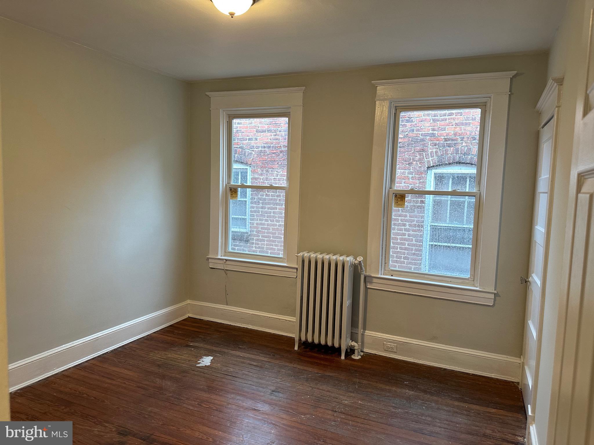4227 Euclid Avenue, Unit B Baltimore, MD 21229 - Photo 47 of 87 an empty room with wooden floor and windows