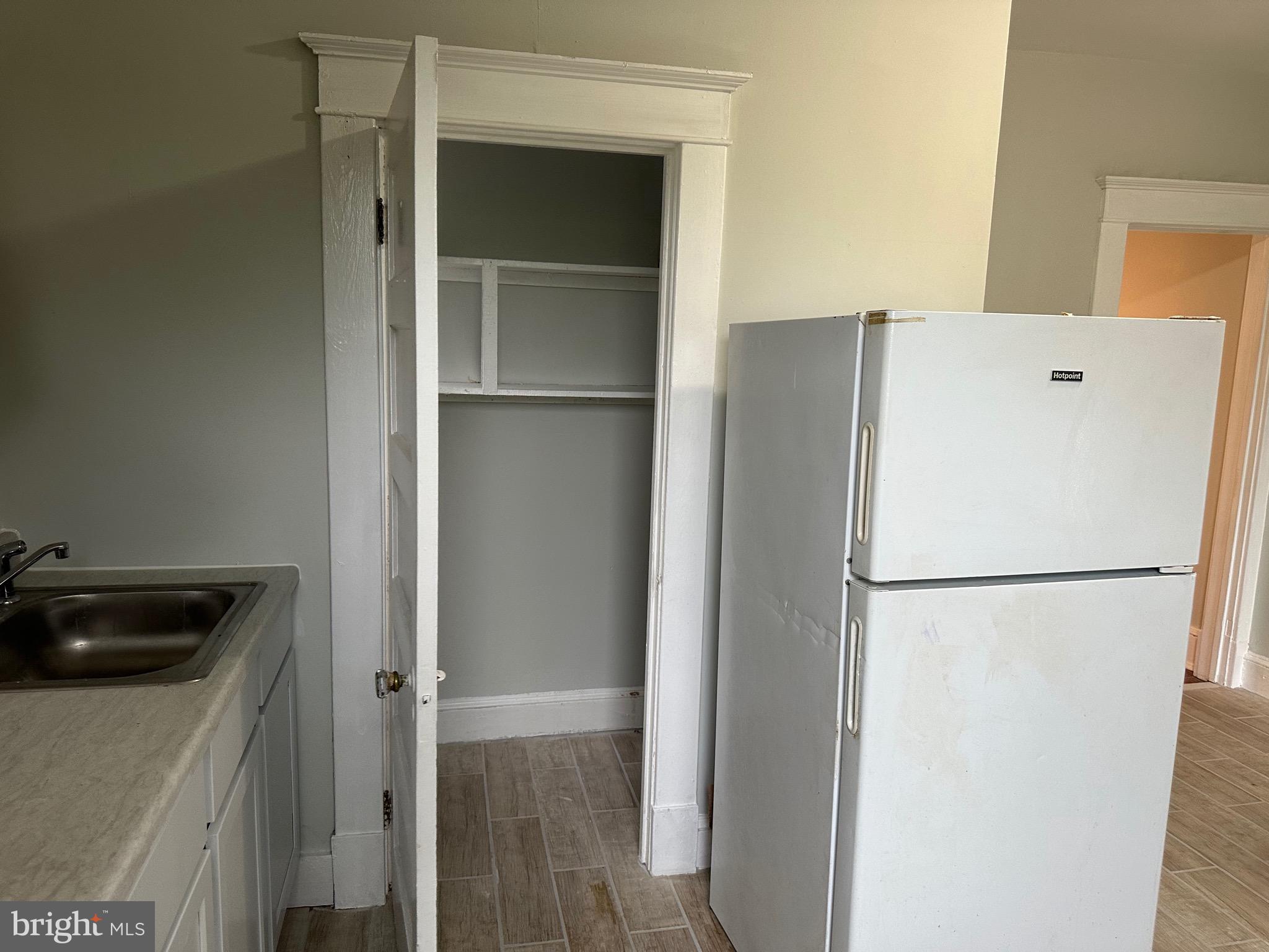 4227 Euclid Avenue, Unit B Baltimore, MD 21229 - Photo 49 of 87 a white refrigerator freezer and a stove sitting inside of a kitchen
