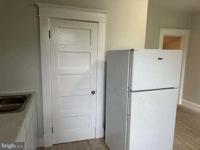 a backyard of a house with lots of green space and glass windows