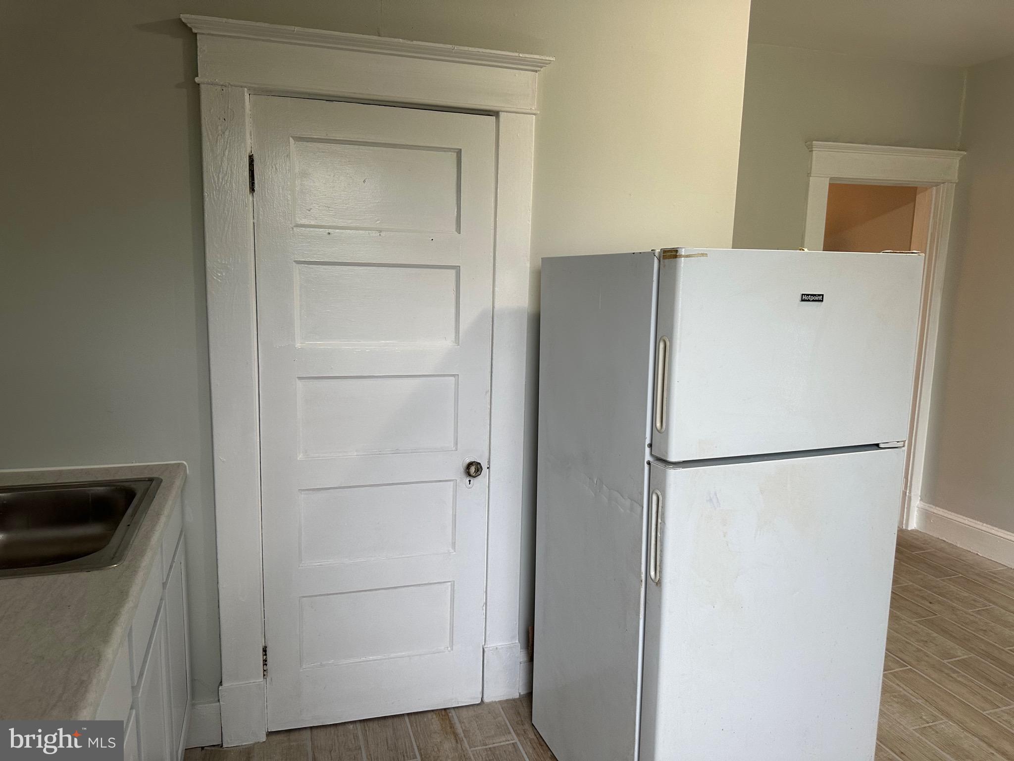 4227 Euclid Avenue, Unit B Baltimore, MD 21229 - Photo 50 of 87 a white refrigerator freezer and a stove sitting inside of a kitchen