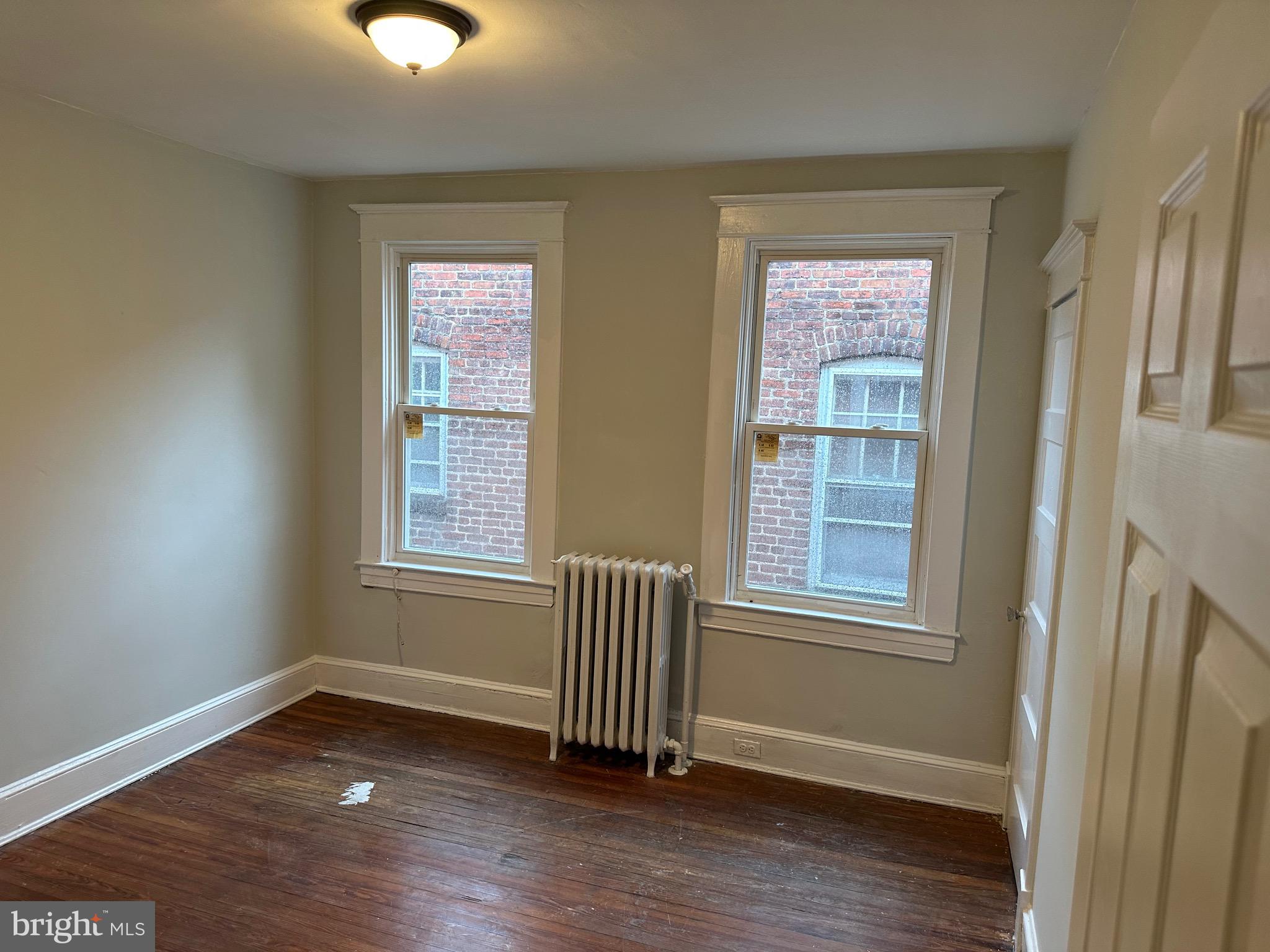 4227 Euclid Avenue, Unit B Baltimore, MD 21229 - Photo 54 of 87 a view of empty room with wooden floor and fan
