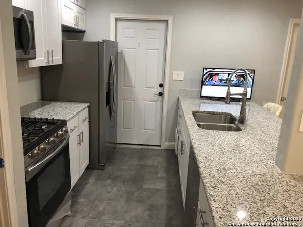 a bathroom with a sink a vanity and a mirror