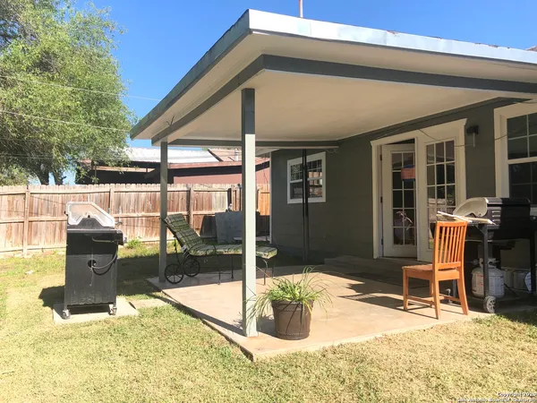 a view of a backyard with sitting area