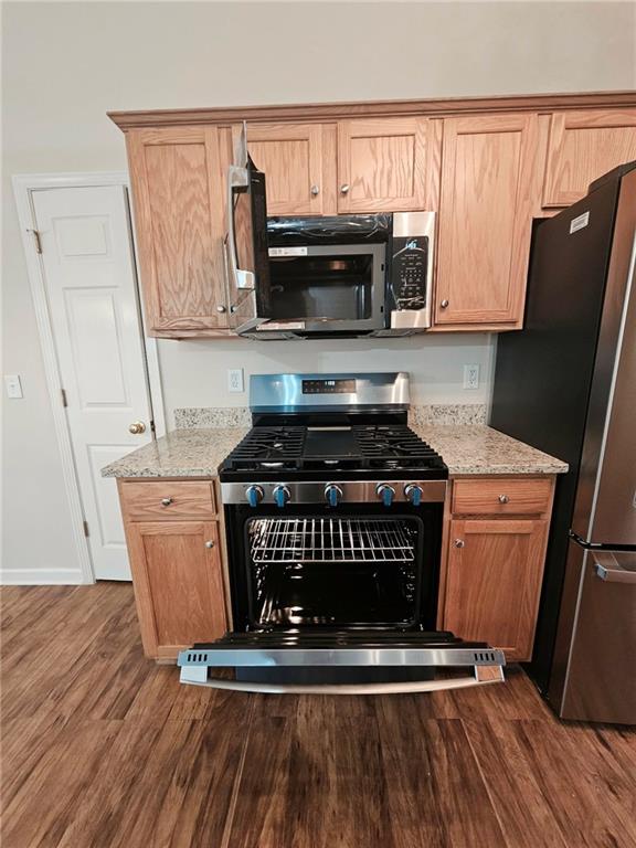 190 Berkley Drive Villa Rica, GA 30180 - Photo 19 of 38 a kitchen with wooden cabinets stove and refrigerator