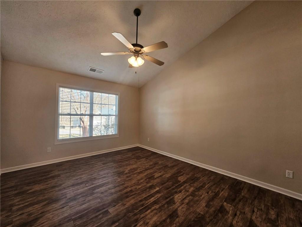 190 Berkley Drive Villa Rica, GA 30180 - Photo 23 of 38 an empty room with wooden floor fan and windows
