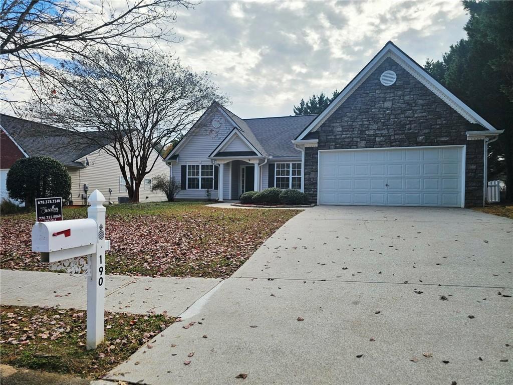 190 Berkley Drive Villa Rica, GA 30180 - Photo 5 of 38 a front view of a house with a yard and garage