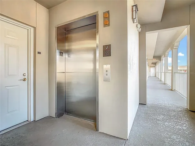 a view of an empty room with cabinet and a window