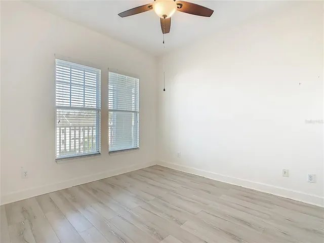 a bathroom with a granite countertop sink mirror vanity and toilet