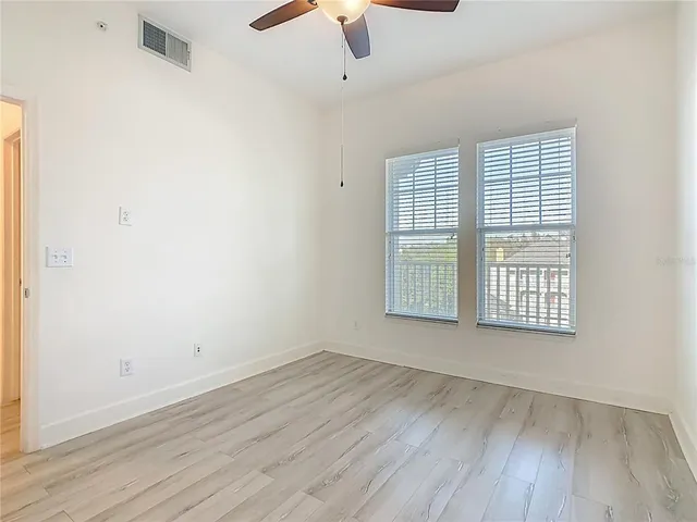 a bathroom with a granite countertop bathtub shower sink vanity and toilet