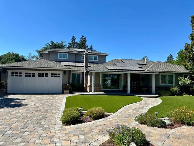 a view of a house with a garden and pathway