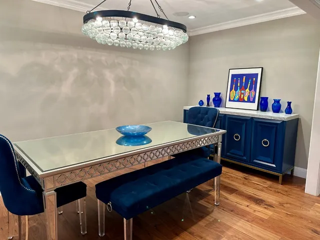 a living room with furniture and a view of kitchen
