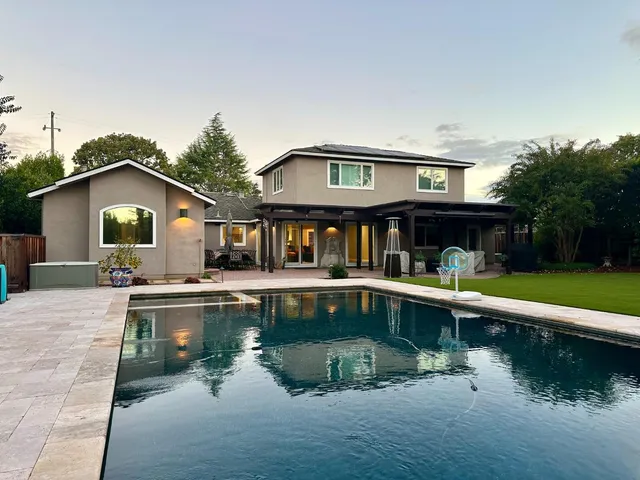 a house with swimming pool in front of it