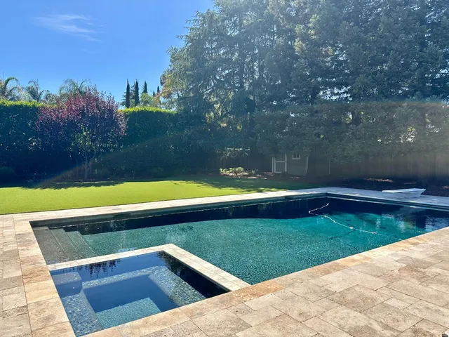 a view of swimming pool with seating space