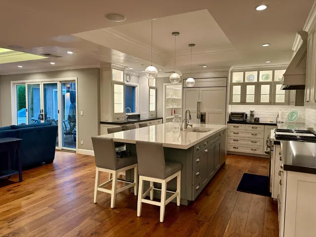 a kitchen with stainless steel appliances granite countertop a sink a stove and a refrigerator