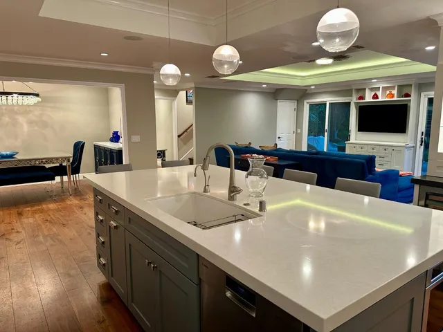 a kitchen with a sink a counter space and cabinets