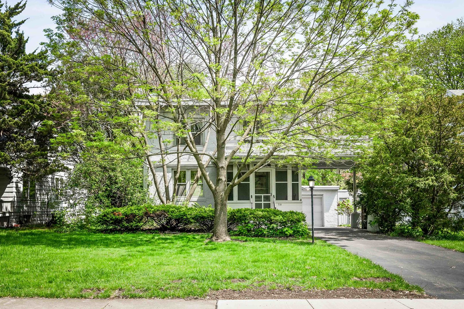 710 Normal Avenue Normal, IL 61761 - Photo 1 of 39 a front view of a house with a garden and trees