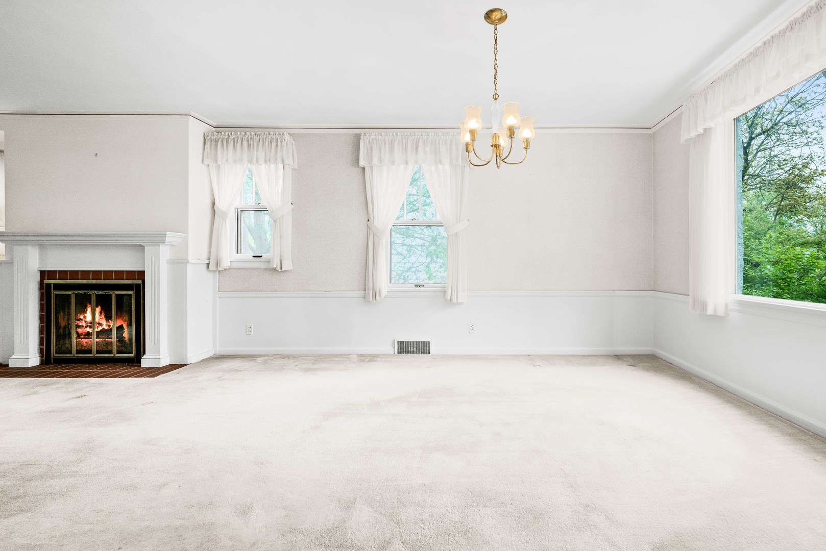 710 Normal Avenue Normal, IL 61761 - Photo 11 of 39 a view of an empty room with a fireplace and a window