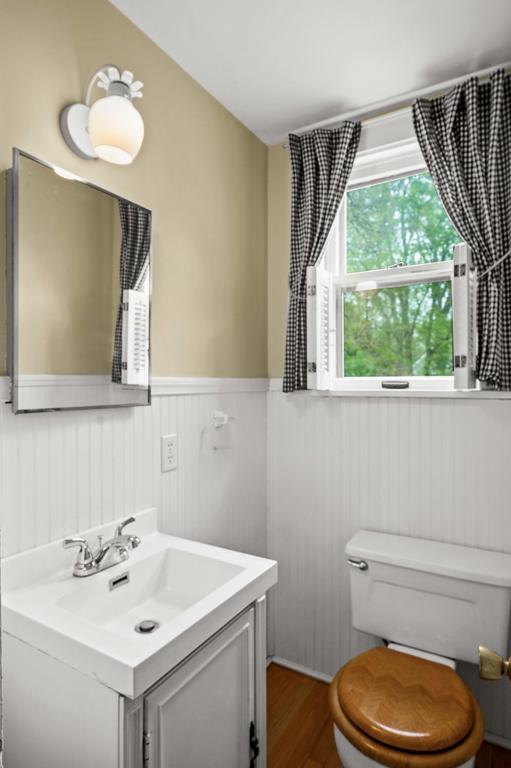 710 Normal Avenue Normal, IL 61761 - Photo 15 of 39 a bathroom with a sink a toilet and a mirror