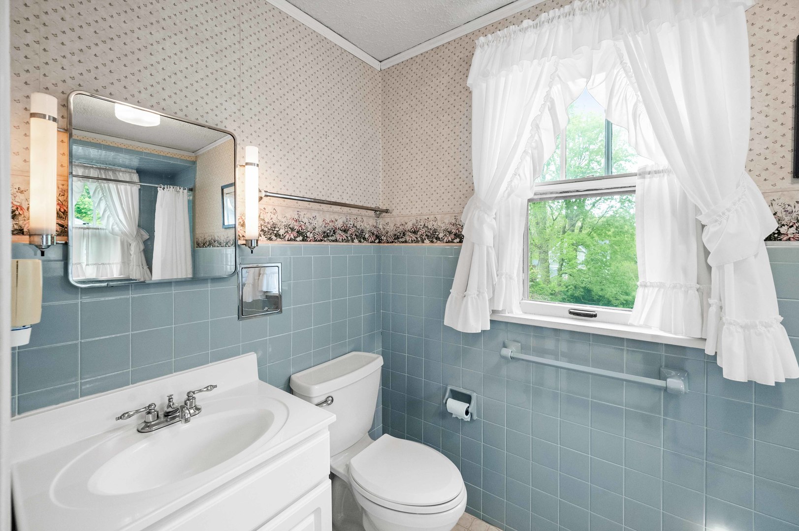 710 Normal Avenue Normal, IL 61761 - Photo 19 of 39 a bathroom with a sink a mirror and a toilet
