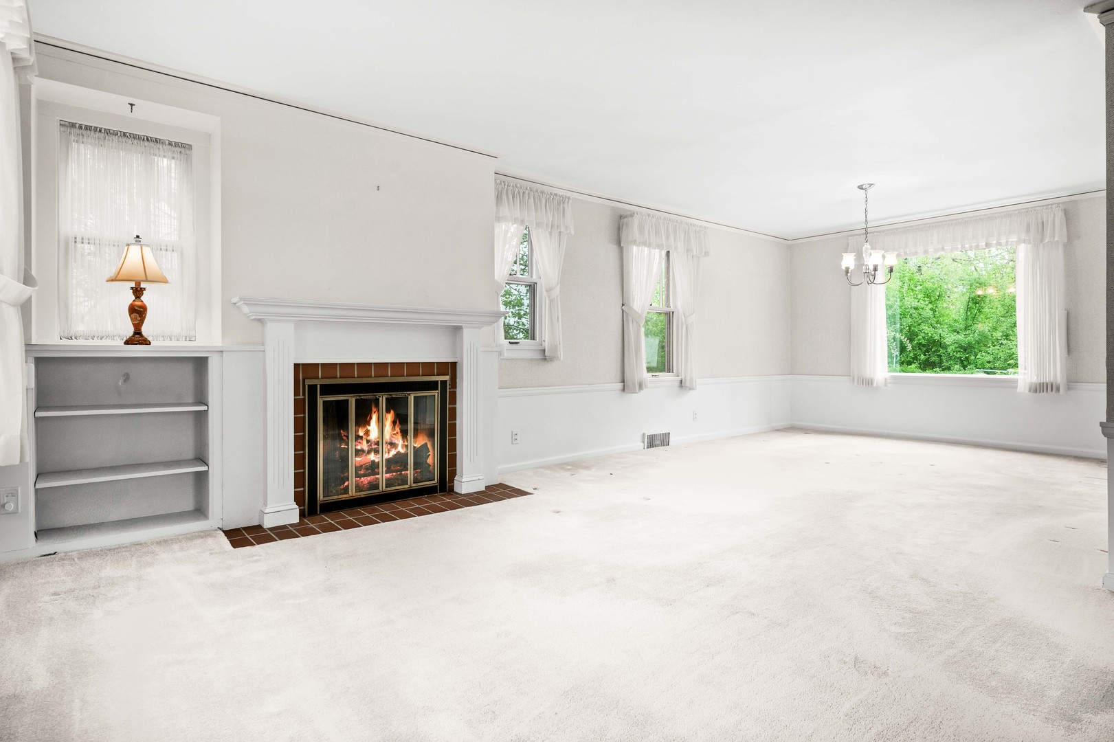710 Normal Avenue Normal, IL 61761 - Photo 10 of 39 a view of an empty room with a fireplace and a window