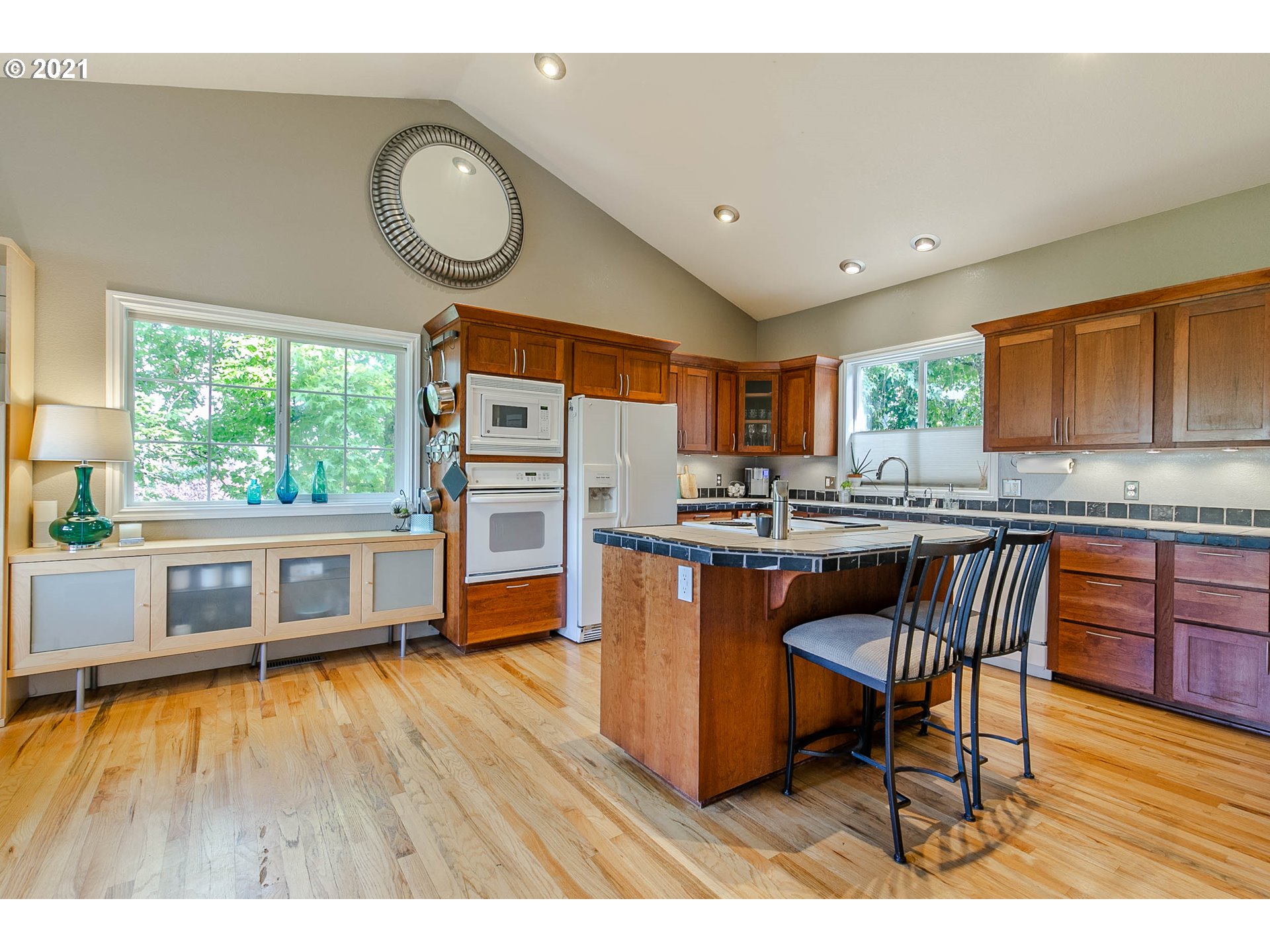 923 Prescott Lane Springfield, OR 97477 - Photo 13 of 32 a kitchen with stainless steel appliances granite countertop a stove a sink dishwasher and a dining table with wooden cabinet