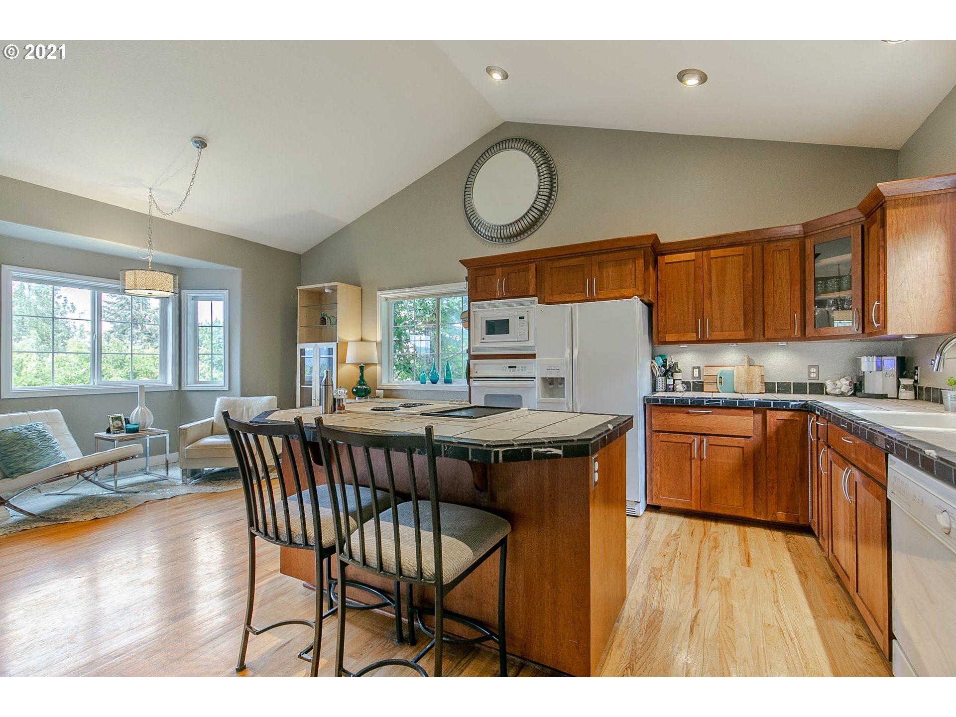 923 Prescott Lane Springfield, OR 97477 - Photo 15 of 32 a open kitchen with stainless steel appliances granite countertop a sink a stove a dining table and chairs
