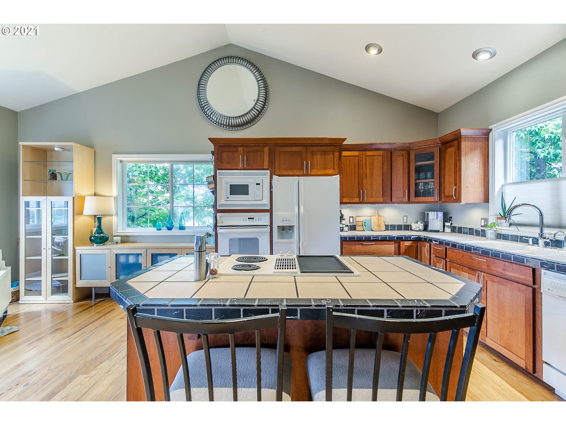 923 Prescott Lane Springfield, OR 97477 - Photo 17 of 32 a kitchen with stainless steel appliances granite countertop a sink a stove a dining table and chairs
