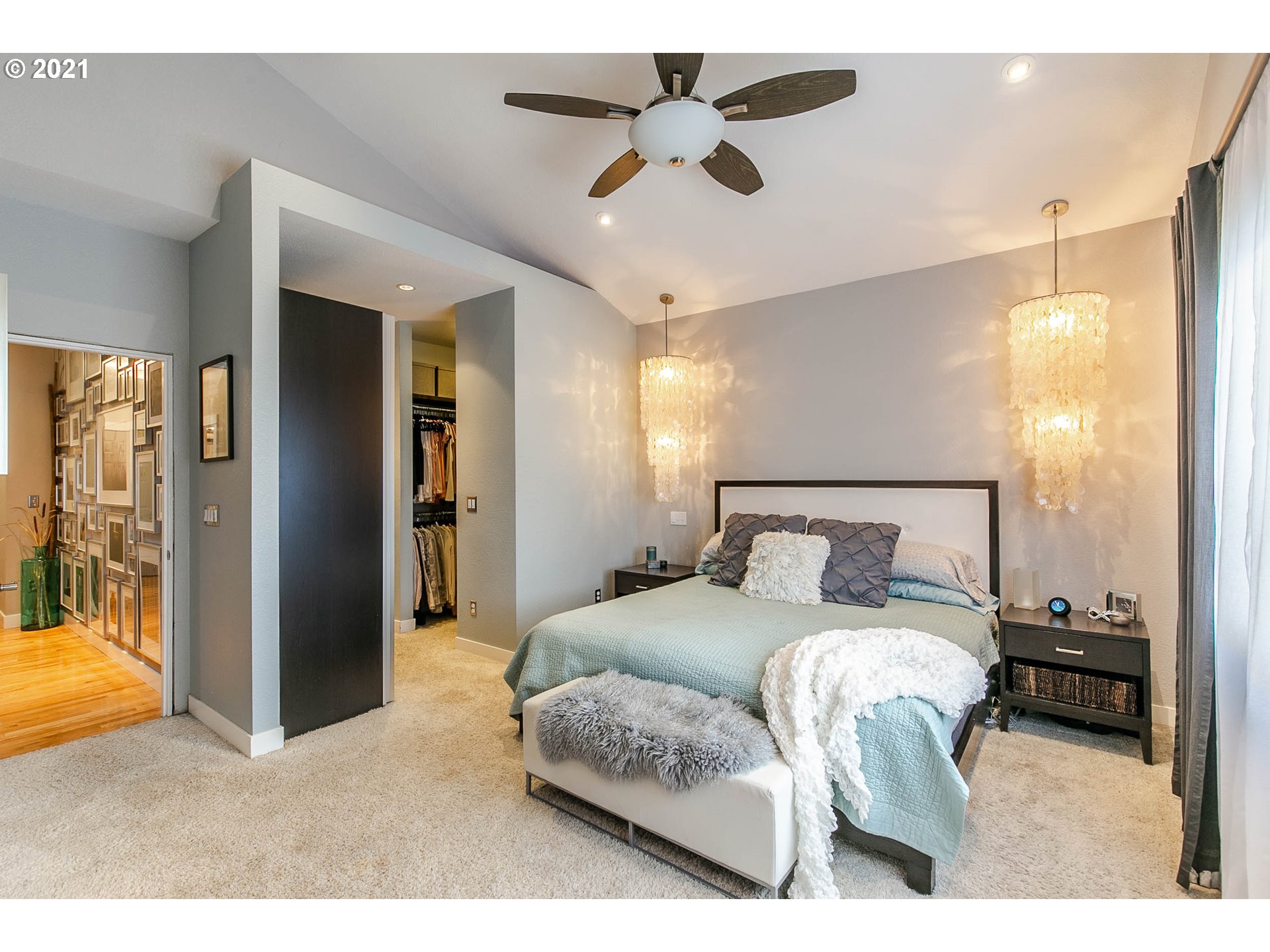 923 Prescott Lane Springfield, OR 97477 - Photo 19 of 32 a bedroom with a bed and a chandelier