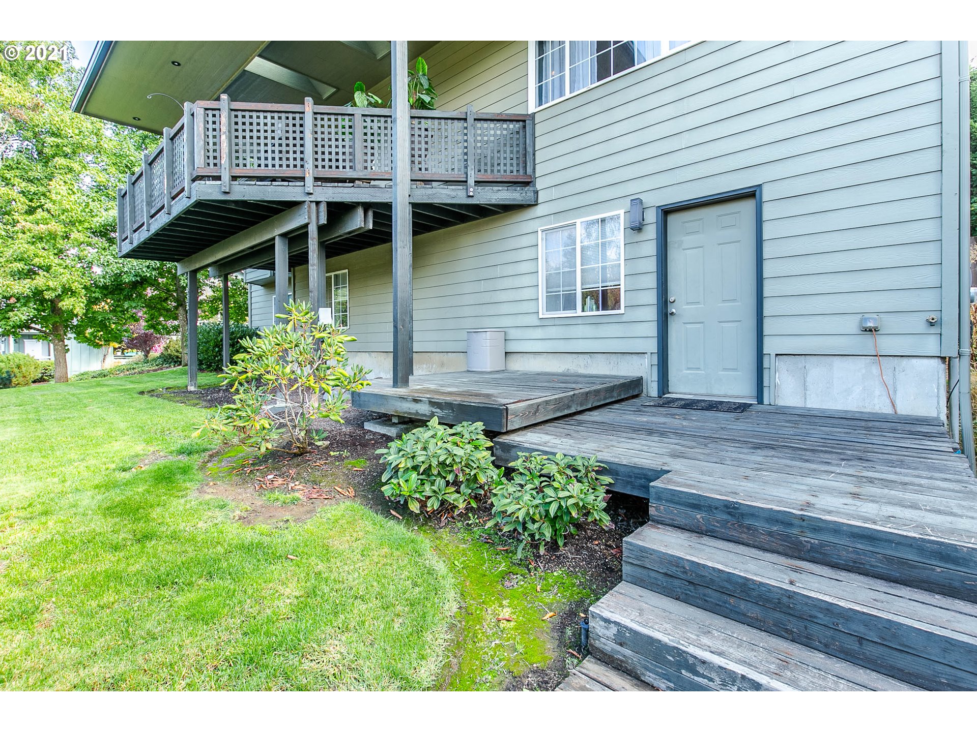 923 Prescott Lane Springfield, OR 97477 - Photo 31 of 32 a view of a house with wooden deck and furniture