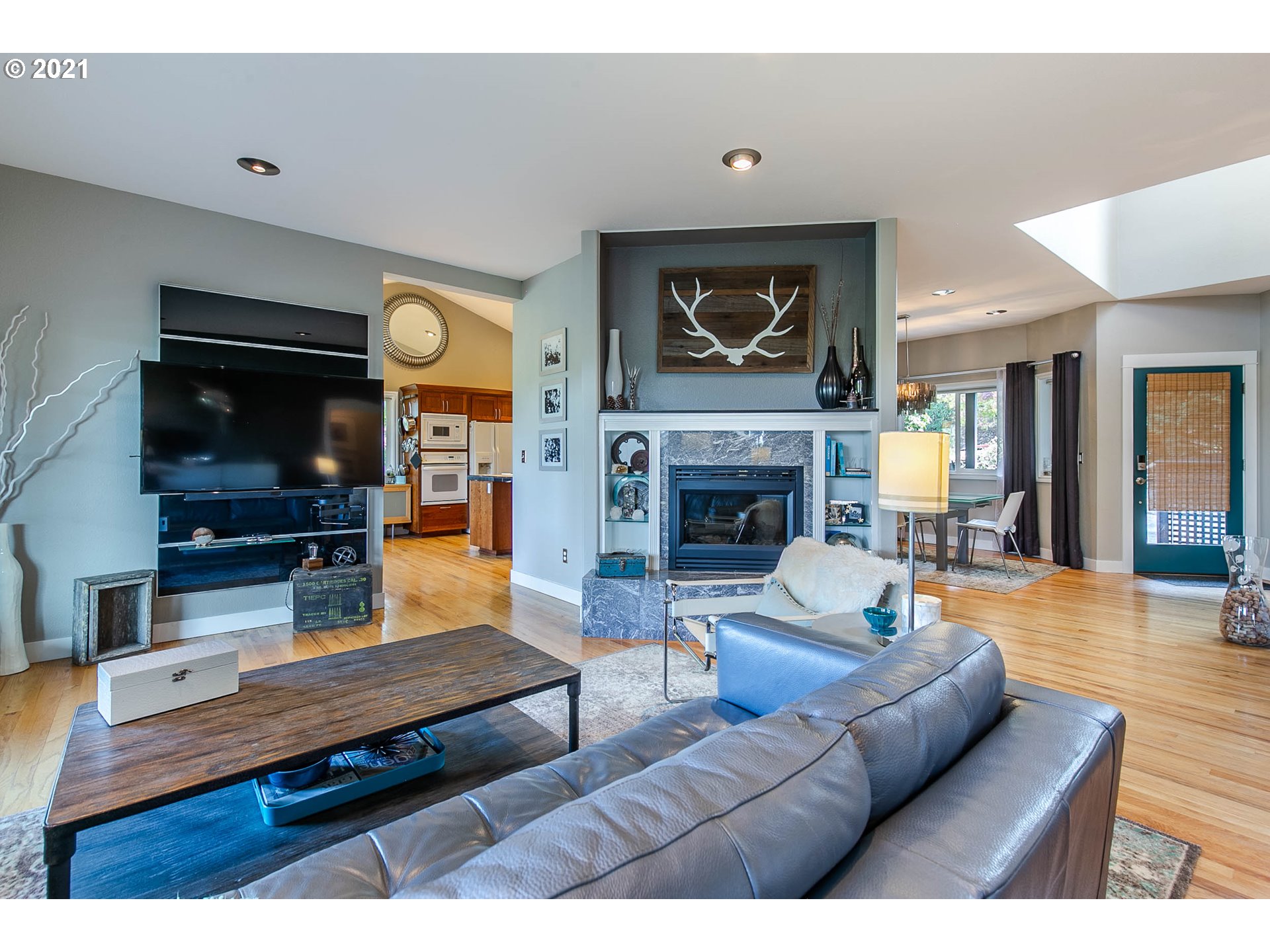923 Prescott Lane Springfield, OR 97477 - Photo 10 of 32 a living room with furniture flat screen tv and a fireplace