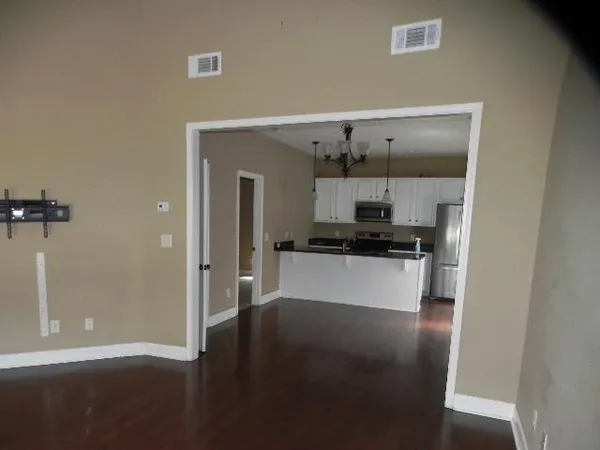 a kitchen with stainless steel appliances a refrigerator and a stove top oven