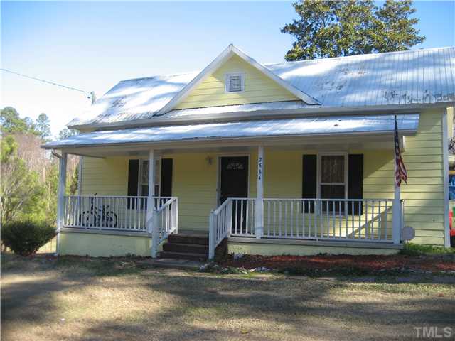 2664 Shotwell Road Clayton, NC 27520 - Photo 1 of 11 Country Home with metal roof, concrete rocking chair front porch. 2.15ac wooded unrestricted lot, home sold as-is, mostly cosmetic repairs needed. Must See!!