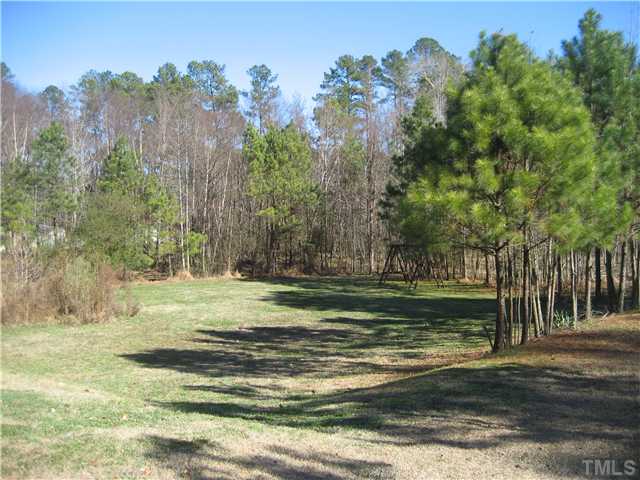 2664 Shotwell Road Clayton, NC 27520 - Photo 11 of 11 Beautiful country setting, middle of creek is the property line. Swingset and basketball goal convey, barn with shelter and fire pit.