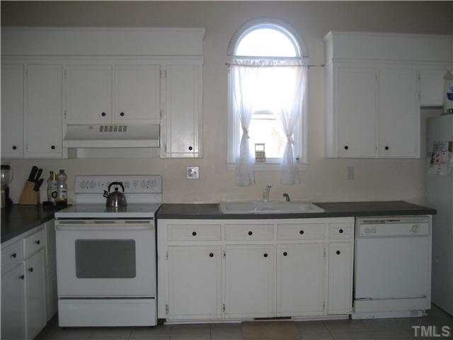 2664 Shotwell Road Clayton, NC 27520 - Photo 3 of 11 Large Eat-In Kitchen with tile floor, palladeum window, lots of cabinets, smooth top range, walk in pantry and frig conveys.