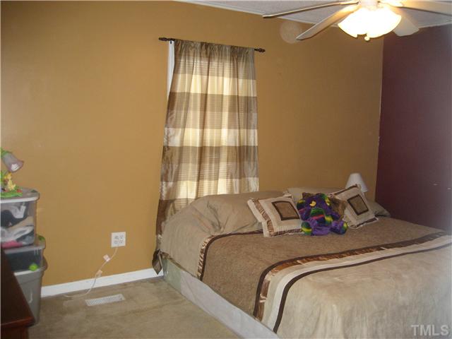 2664 Shotwell Road Clayton, NC 27520 - Photo 9 of 11 Master Bedroom with ceiling fan and walk in closet.