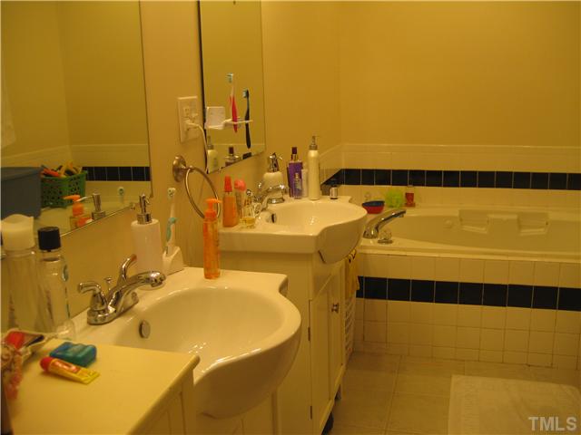 2664 Shotwell Road Clayton, NC 27520 - Photo 10 of 11 Master Bath with dual sinks, jetted 6ft tub/separate shower, water closet and tile floor.