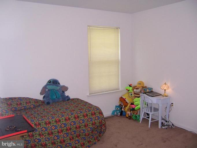 11559 San Rafael Road Lusby, MD 20657 - Photo 9 of 10 a bedroom with a bed and a window