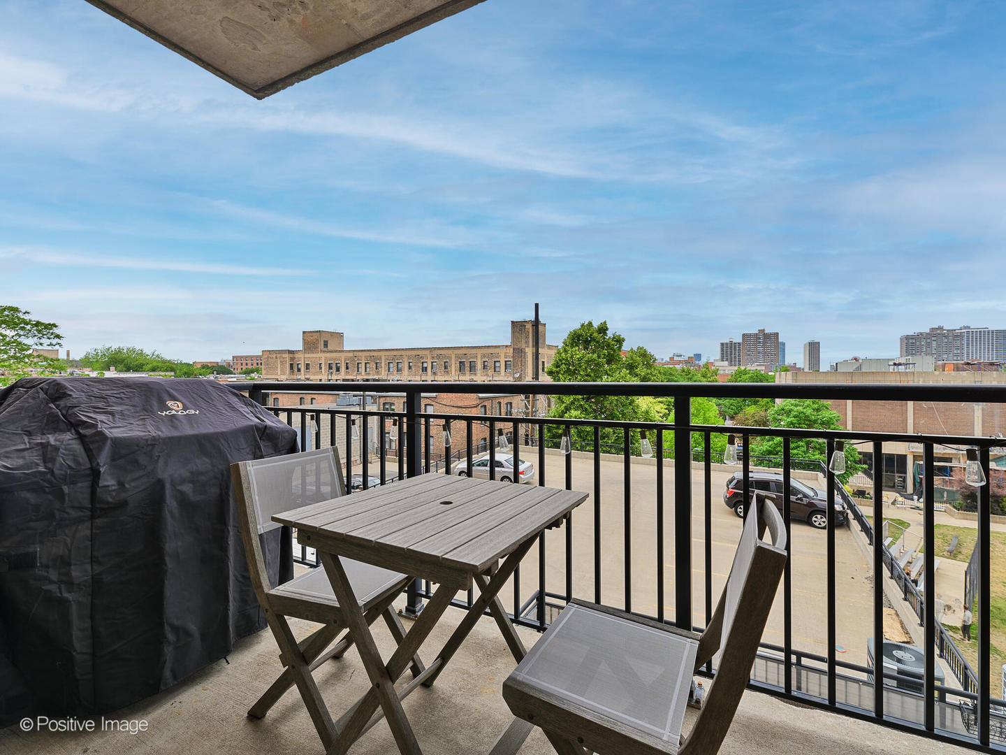 828 West Grace Street, Unit 508 Chicago, IL 60613 - Photo 12 of 15 a view of a balcony with wooden chairs and floor to ceiling window